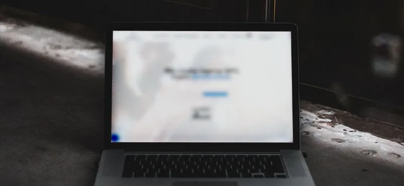 Blurred out landing page on a laptop, but the CTA is still clear